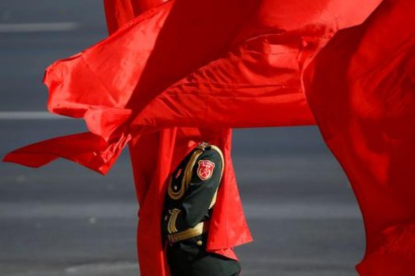 REPRESENTATIVE IMAGE: A honour guard holds a red flag as he stands at attention before a welcoming ceremony for Japanese Prime Minister Shinzo Abe (not pictured) in Beijing, China October 26, 2018. REUTERS