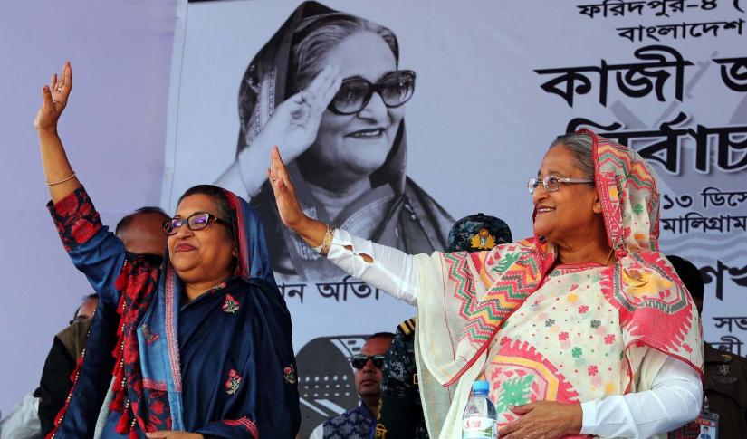 Awami League President and Prime Minister Sheikh Hasina and his sister Sheikh Rehana wave hands at arally in Faridpur’s Bhanga on Thursday (Dec 13). PID