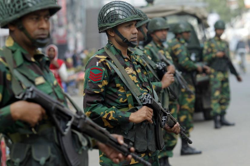 Army soldiers stand guard on a street during the 2014 parliamentary elections in Dhaka. Reuters