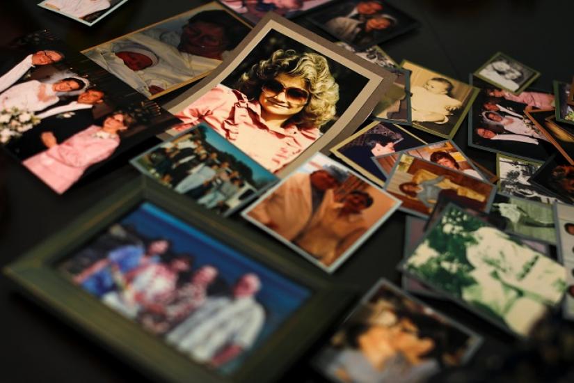 Darlene Coker is shown on a kitchen table full of many personal pictures of her family life in California, U.S. August 15, 2018. REUTERS/FILE PHOTO