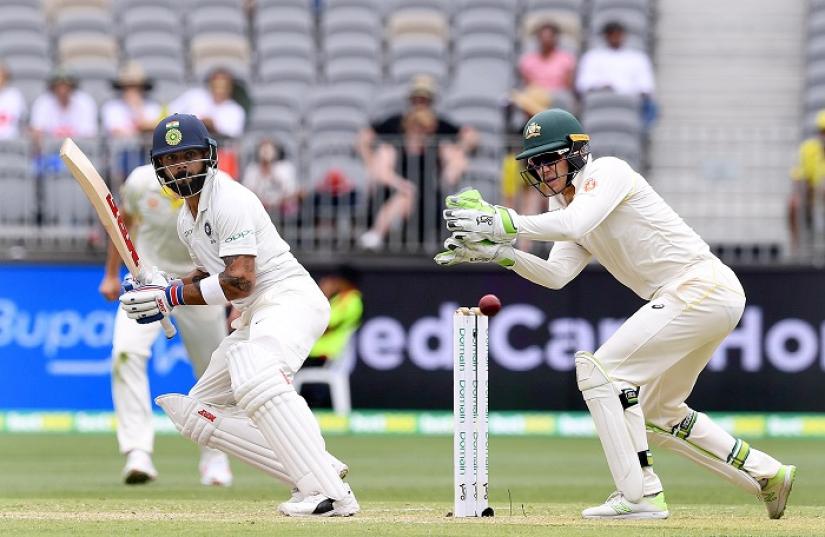 India`s captain Virat Kohli plays a shot watched by Australia`s captain and wicketkeeper Tim Paine on day two of the second test match between Australia and India at Perth Stadium in Perth, Australia, December 15, 2018. AAP/Dave Hunt/via REUTERS