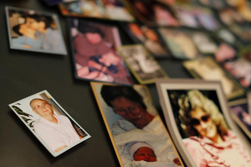 Darlene Coker is shown on a kitchen table full of many personal pictures of her family life in California, U.S. August 15, 2018. REUTERS/FILE PHOTO