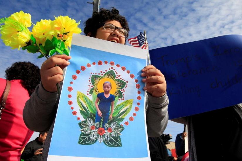 A woman holds a picture of Jakelin, a 7-year-old girl who died in U.S. custody after crossing illegally from Mexico to the U.S., during a protest held to demand justice for her in El Paso, U.S. December 15, 2018. REUTERS