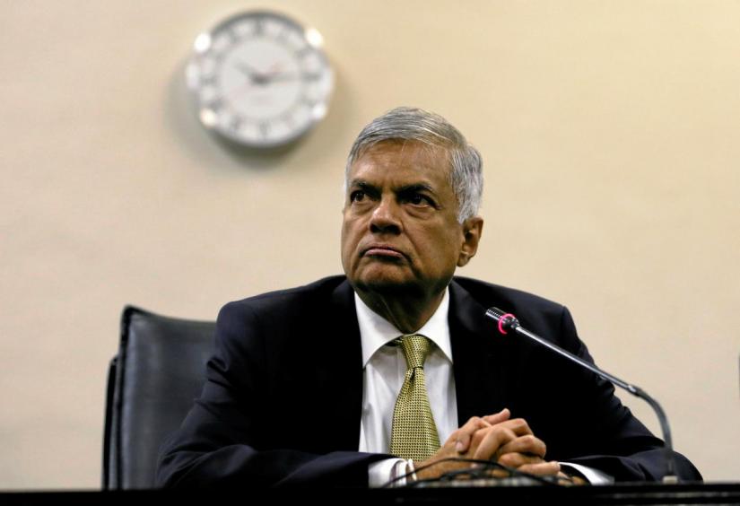 Sri Lankan Prime Minister Ranil Wickremesinghe (C) looks on at a news conference after he survived a no confidence vote in parliament in Colombo, Sri Lanka April 4, 2018. REUTERS/FILE PHOTO
