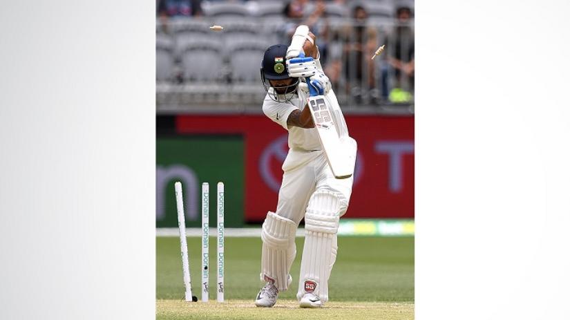 India`s Murali Vijay is bowled out by Australia`s Mitchell Starc on day two of the second test match between Australia and India at Perth Stadium in Perth, Australia, December 15, 2018. AAP/Dave Hunt/via REUTERS