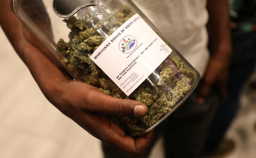 A man holds a jar full of cannabis buds before they were handed out by activist Steven Thapelo Khundu at the expo entrance, encouraging attendees to bring them inside, during the opening of the four-day expo in Pretoria, South Africa, December 13, 2018. REUTERS