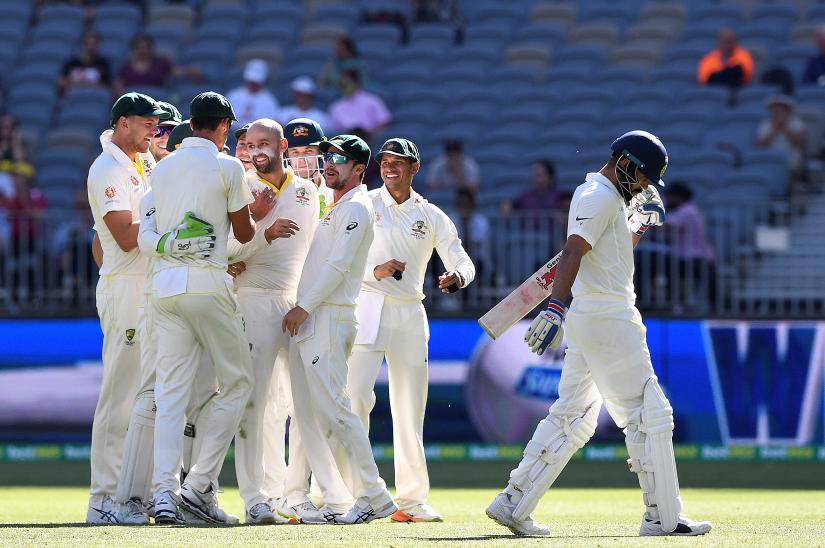 Australia's players celebrate the dismissal of India's captain Virat Kohli (R) on day four of the second test match between Australia and India at Perth Stadium in Perth, Australia, December 17, 2018. AAP/Dave Hunt via REUTERS