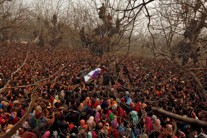 People gather around the body of Mohd Waseem Wagay, a suspected militant, who according to local media was killed in a gun battle with Indian security forces, Nov 25, 2018. REUTERS