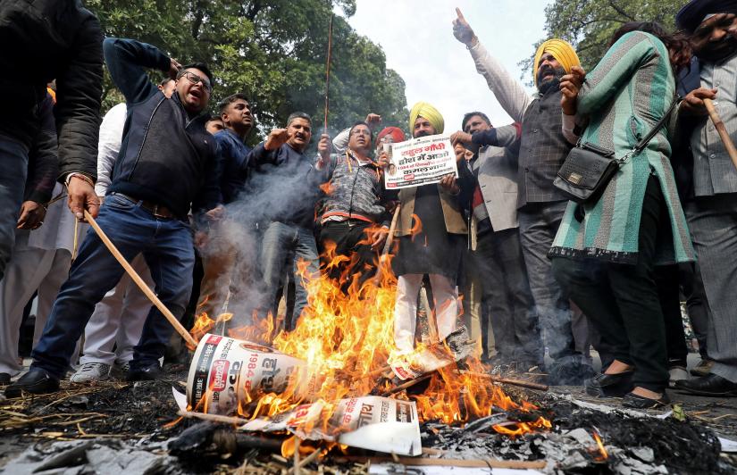 People burn placards and effigies of India`s main opposition Congress party`s leaders Sajjan Kumar and Kamal Nath during a protest near Congress party`s headquarters in New Delhi, India, December 17, 2018. REUTERS