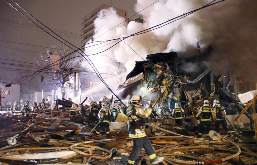 Firefighters operate at the site where a large explosion occurred at a restaurant in Sapporo, Hokkaido, northern Japan, in this photo taken by Kyodo December 16, 2018. Mandatory credit Kyodo--via REUTERS