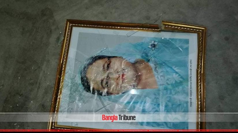 Prime Minister Sheikh Hasina's picture was shattered when Awami League's Dhaka-15 candidate Kamal Ahmed Majumder's election office was attacked on Tuesday (Dec 18).