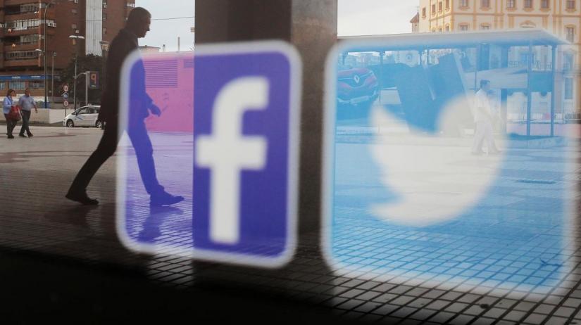 Facebook and Twitter logos are seen on a shop window in Malaga, Spain, June 4, 2018. REUTERS/File Photo