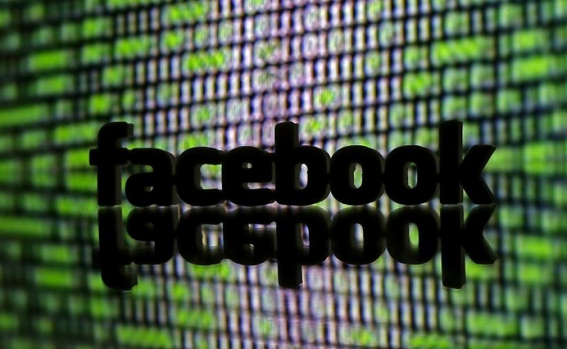 A 3D printed Facebook logo is seen in front of displayed cyber code in this illustration taken March 22, 2016. REUTERS/FILE PHOTO