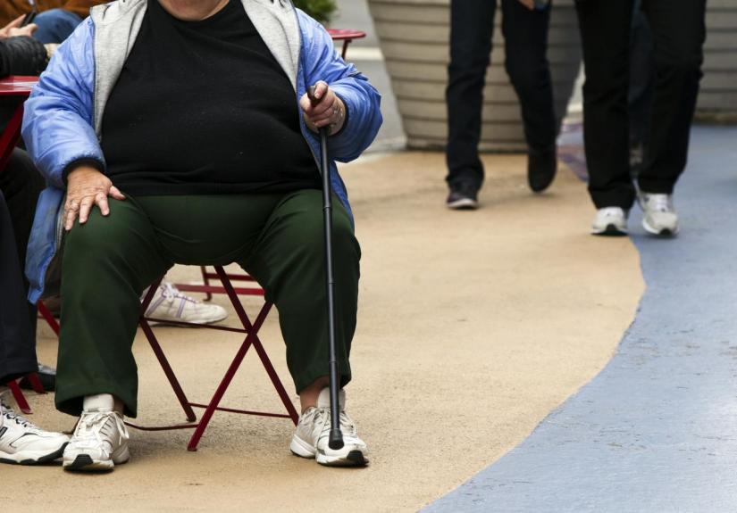 An overweight woman sits on a chair in Times Square in New York, May 8, 2012. REUTERS/FILE PHOTO