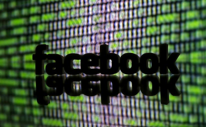 A 3D printed Facebook logo is seen in front of displayed cyber code in this illustration taken March 22, 2016. REUTERS/file photo