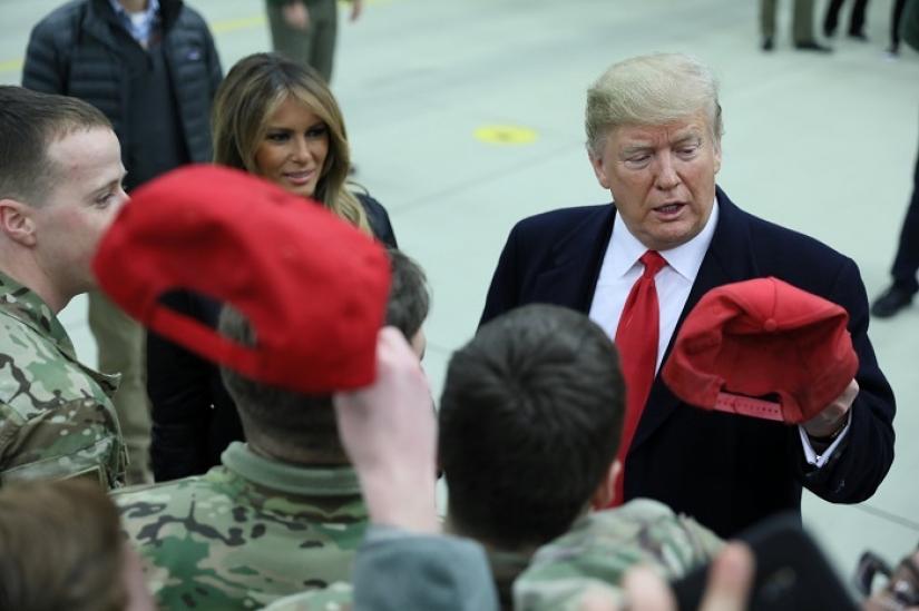 US President Donald Trump holds a cap while visiting U.S. troops at Ramstein Air Force Base, Germany, Dec 27, 2018. REUTERS