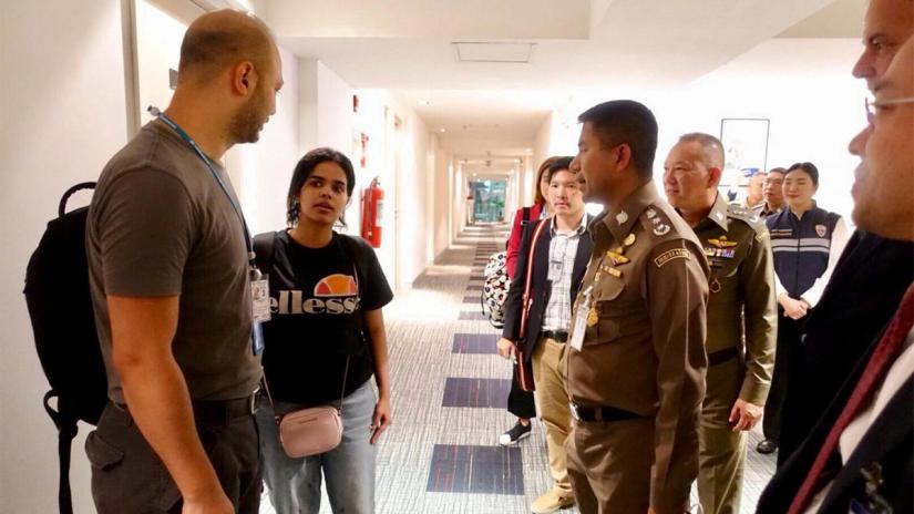 Saudi teen Rahaf Mohammed al-Qunun is greeted by Thai immigration authorities at a hotel inside Suvarnabhumi Airport in Bangkok, Thailand January 7, 2019. Thailand Immigration Police via REUTERS