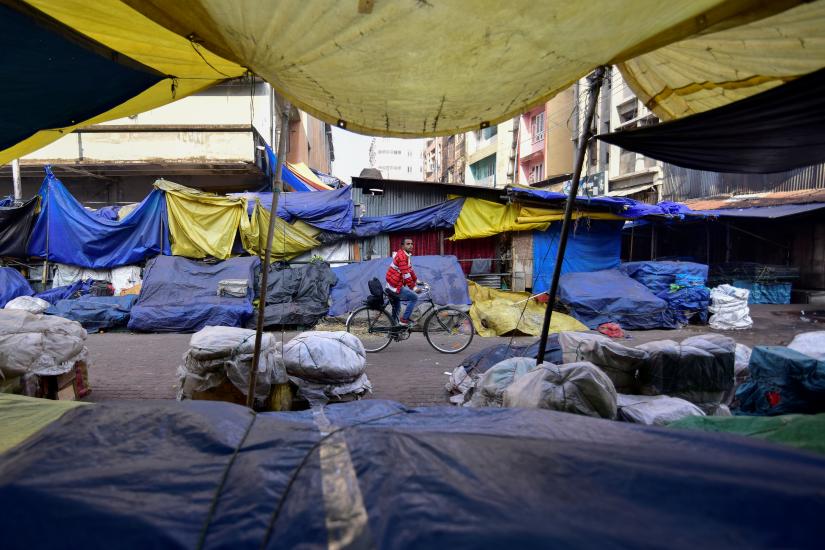 A man pedals his bicycle through a closed market during the strike called by All Assam Students Union (AASU) and the North East Students` Organisation (NESO) to protest against the government`s bid to pass a bill in parliament to give citizenship to non-Muslims from neighbouring countries, in Guwahati, India January 8, 2019. REUTERS