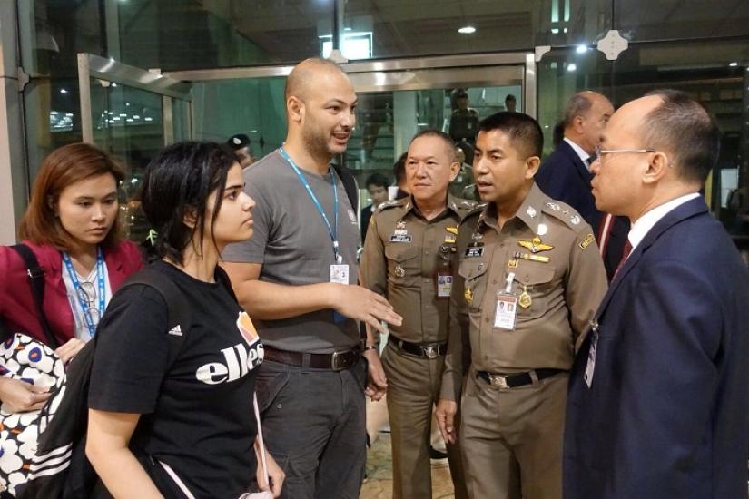 Saudi teen Rahaf Mohammed al-Qunun is seen with Thai immigration authorities at a hotel inside Suvarnabhumi Airport in Bangkok, Thailand January 7, 2019. Thailand Immigration Police via REUTERS/File Photo