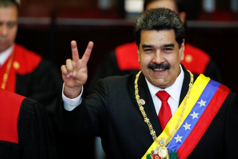 Venezuelan President Nicolas Maduro gestures after receiving the presidential sash during the ceremonial swearing-in for his second presidential term, at the Supreme Court in Caracas, Venezuela January 10, 2019. REUTERS