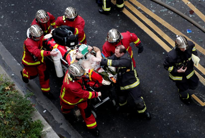 Firemen wheel a stretcher carrying a man injured in an explosion in a bakery shop in the 9th District in Paris, France, January 12, 2019. REUTERS