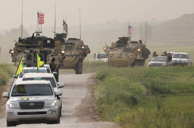 Kurdish fighters from the People`s Protection Units (YPG) head a convoy of U.S military vehicles in the town of Darbasiya next to the Turkish border, Syria April 28, 2017. REUTERS/file photo