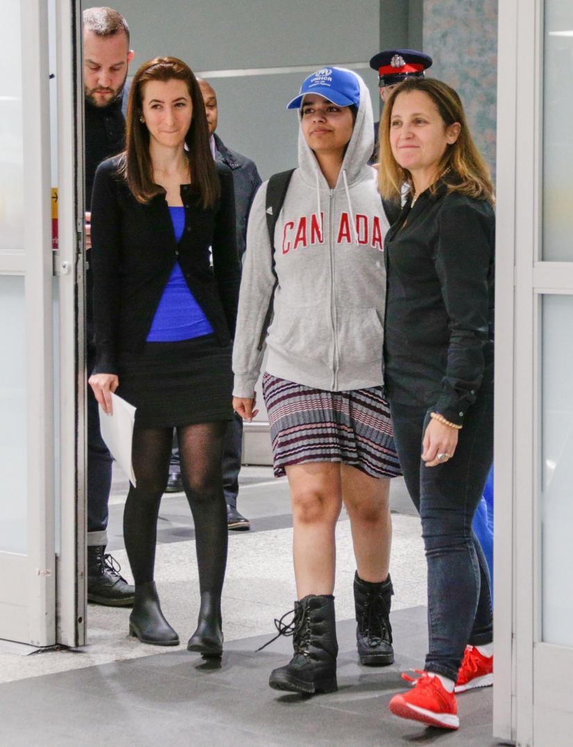 Rahaf Mohammed al-Qunun (C) accompanied by Canadian Minister of Foreign Affairs Chryistia Freeland (R), arrives at Toronto Pearson International Airport in Toronto, Ontario, Canada January 12, 2019. REUTERS