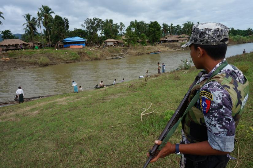 A Myanmar border guard police officer stands guard in Tin May village, Buthidaung township, northern Rakhine state, Myanmar July 14, 2017.