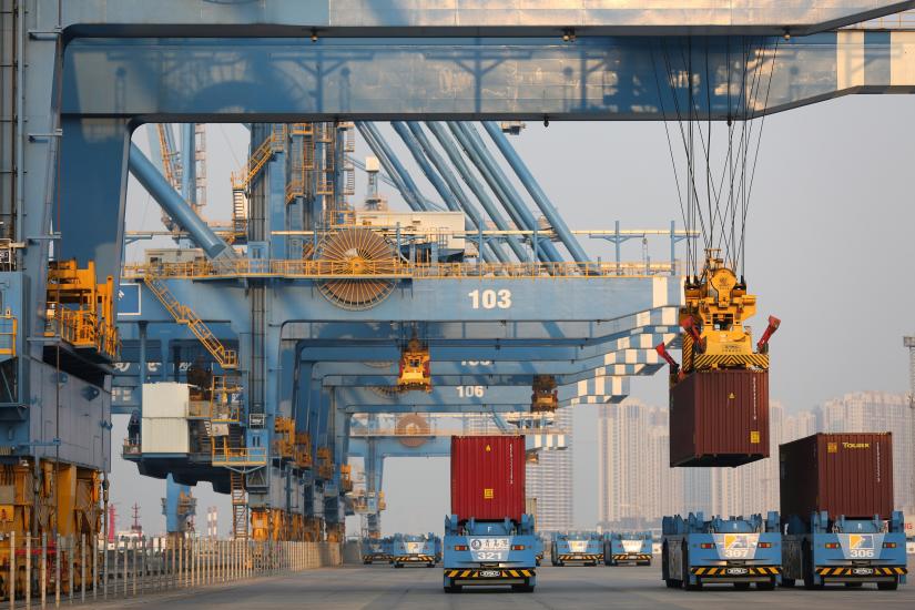 Automated guided vehicles (AGV) transport containers at an automated container terminal in Qingdao port, Shandong province, China January 1, 2019. REUTERS