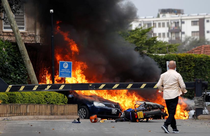 Cars are seen on fire at the scene where explosions and gunshots were heard at the Dusit hotel compound, in Nairobi, Kenya January 15, 2019. REUTERS