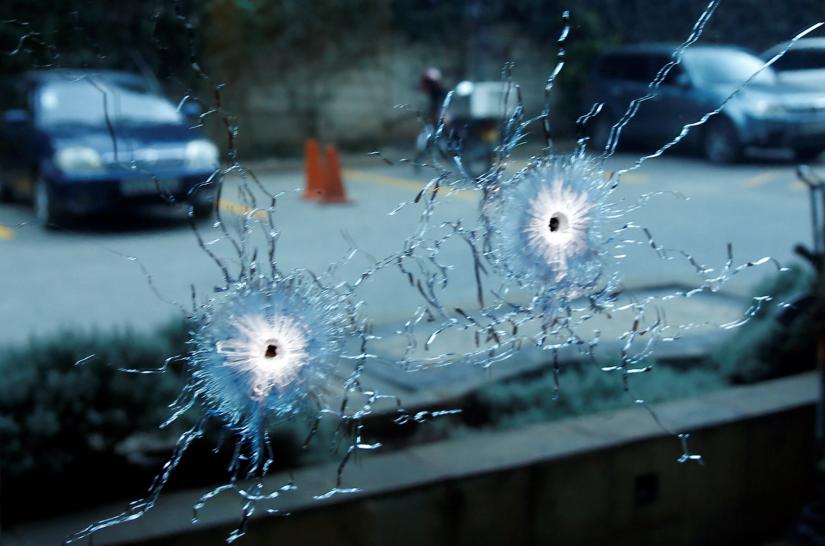 A glass damaged by bullets is seen at the scene where explosions and gunshots were heard at the Dusit hotel compound, in Nairobi, Kenya January 15, 2019. REUTER