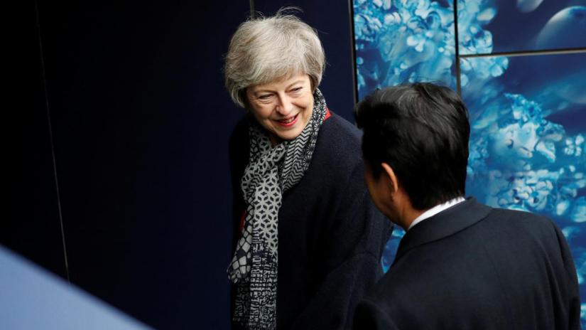 Britain`s Prime Minister Theresa May speaks to Japanese Prime Minister Shinzo Abe during a visit to Twickenham Rugby Stadium, in London, Britain January 10, 2019. REUTERS