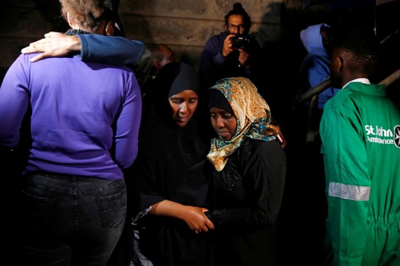 A civilian (2nd R) meets with friends and family after being evacuated from the scene where gunmen blasted their way into a hotel and office complex in Nairobi, Kenya, January 16, 2019. REUTERS