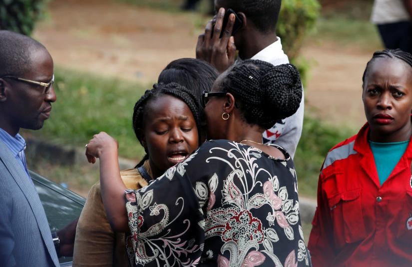 Unidentified relatives react outside the scene where explosions and gunshots were heard at the Dusit hotel compound, in Nairobi, Kenya January 16, 2019