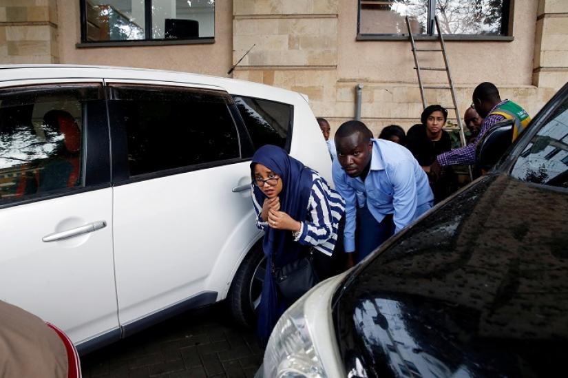 People are evacuated by a member of security forces at the scene where explosions and gunshots were heard at the Dusit hotel compound, in Nairobi, Kenya January 15, 2019. REUTERS