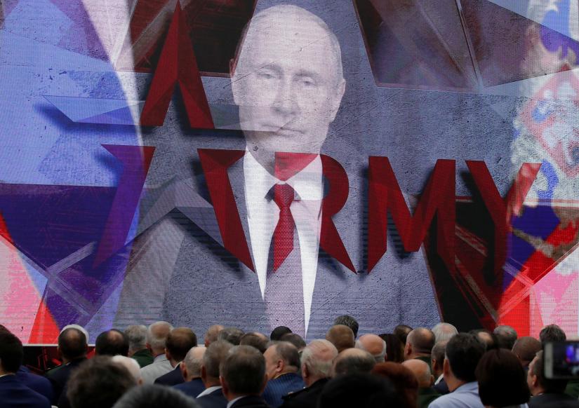 Russian President Vladimir Putin addresses participants via a video link during the opening of the annual international military-technical forum `ARMY` at Patriot Expocentre in Moscow Region, Russia August 21, 2018. REUTERS