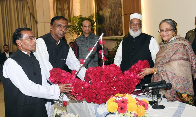 Leaders of Awami League’s Gopalganj’s Kotalipara and Tungipara Upazilas units greets party President and Prime Minister Sheikh Hasina with flowers at her official residence on Sunday (Jan 20). PID