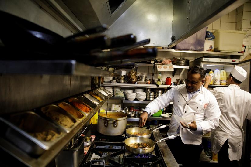 Abdul Ahad, owner of the City Spice curry house, cooks a vegan meal in the kitchen of his restaurant on Brick Lane in London, Britain January 7, 2019. Picture taken January 7, 2019. REUTERS