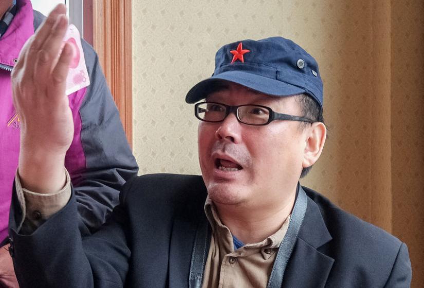 Yang Hengjun, author and former Chinese diplomat, who is now an Australian citizen, gestures in an unspecified location in Tibet, China, sometime in mid-July, 2014 in this social media image obtained by REUTERS.