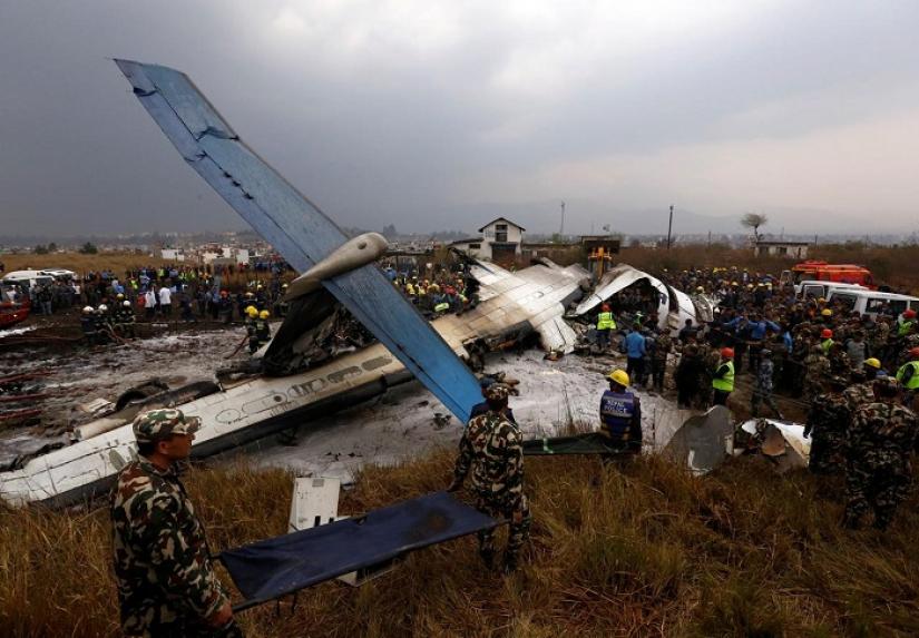 Rescue workers work at the wreckage of a US-Bangla airplane after it crashed at the Tribhuvan International Airport in Kathmandu, Nepal March 12, 2018. REUTERS/File Photo
