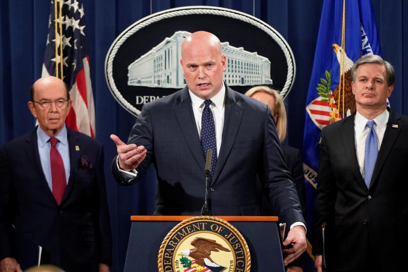 Acting Attorney General Matthew Whitaker speaks flanked by U.S. Commerce Secretary Wilbur Ross (L) and FBI Director Christopher Wray (R) during a news conference to announce indictments against China`s Huawei Technologies Co Ltd, several of its subsidiaries and its chief financial officer Meng Wanzhou, at the Justice Department in Washington, U.S., January 28, 2019. REUTERS