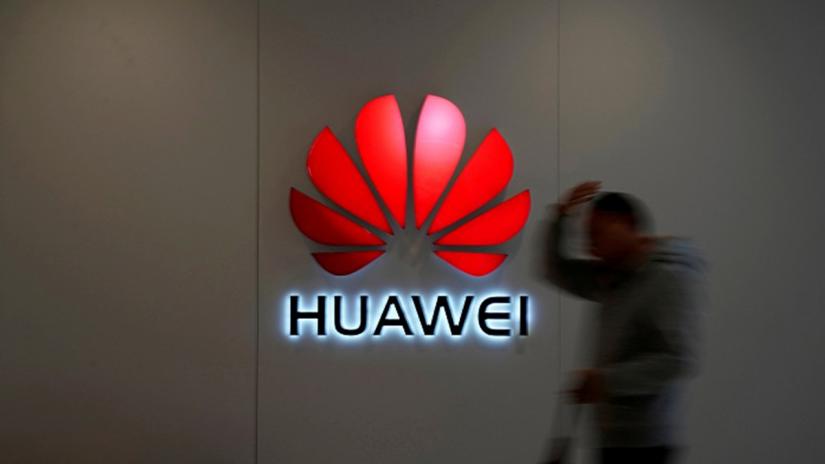 A man walks by a Huawei logo at a shopping mall in Shanghai, China, Dec. 6, 2018. REUTERS/File Photo