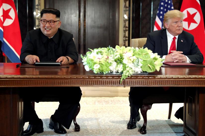 U.S. President Donald Trump and North Korea`s leader Kim Jong Un hold a signing ceremony at the conclusion of their summit at the Capella Hotel on the resort island of Sentosa, Singapore June 12, 2018. Picture taken June 12, 2018. REUTERS