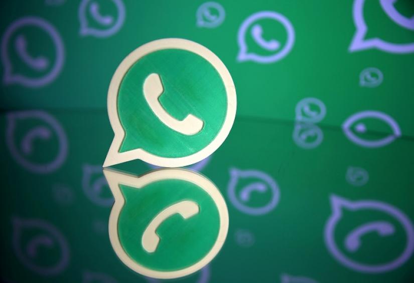 A 3D printed Whatsapp logo is seen in front of a displayed Whatsapp logo in this illustration Sept 14, 2017. REUTERS/File Photo