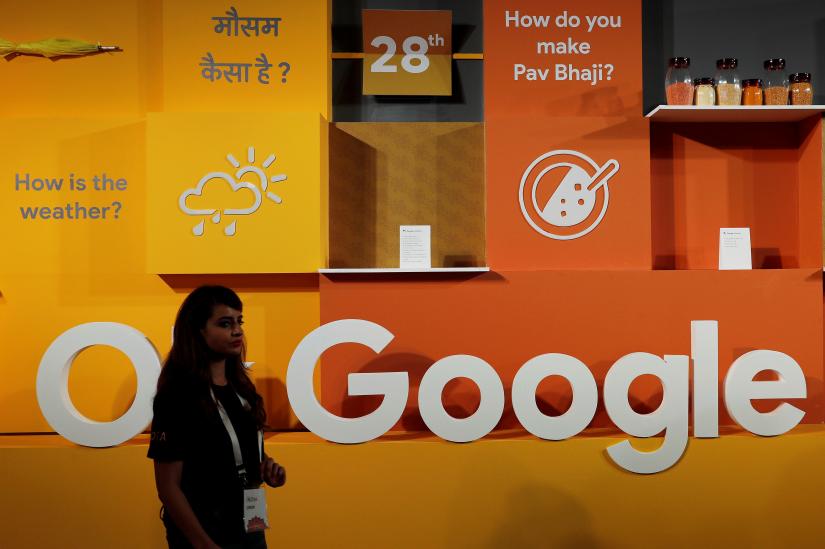 A woman walks past the logo of Google during an event in New Delhi, India, August 28, 2018. Picture taken August 28, 2018. REUTERS
