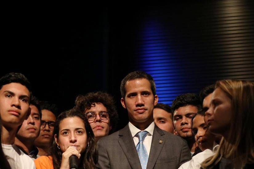 Venezuelan opposition leader Juan Guaido, who many nations have recognized as the country`s rightful interim ruler, is seen with students in Caracas, Venezuela February 11, 2019. REUTERS