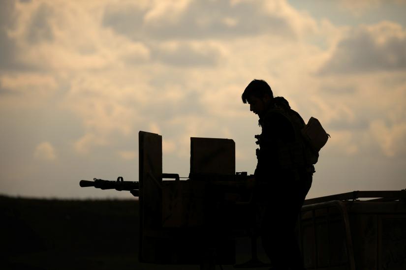 A member of Syrian Democratic Forces (SDF) stands on a pick up truck mounted with a weapon near Baghouz, Deir Al Zor province, Syria February 11, 2019. REUTERS