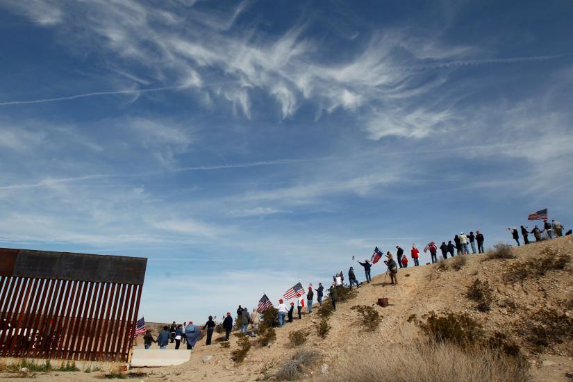Demonstrators holding US flags gather at the open border to make a human wall in support of the construction of the new border wall between US and Mexico, in Ciudad Juarez, Mexico February 9, 2019. REUTERS