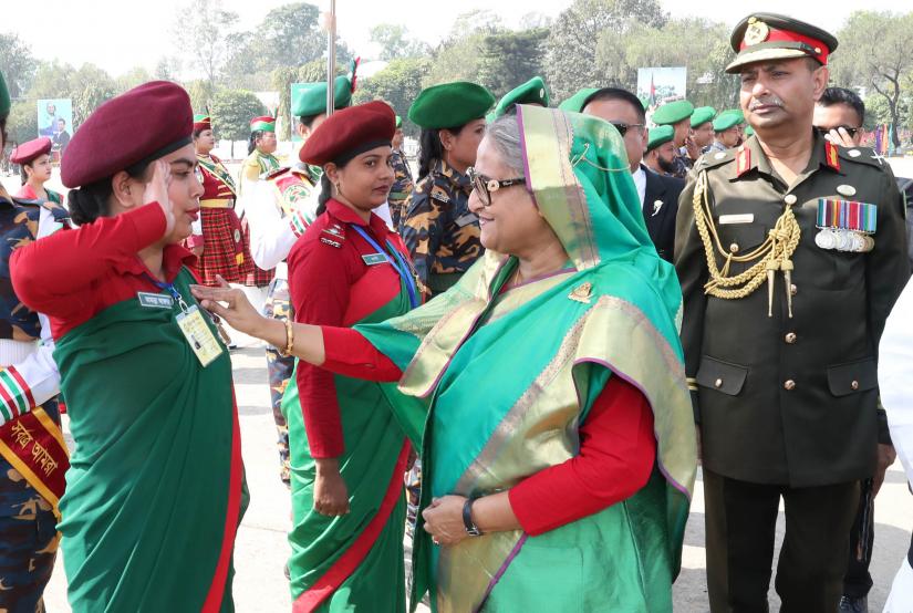Prime Minister Sheikh Hasina put a put a badge on a female Ansar member the Ansar and Village Defence Party (VDP) academy in Gazipur’s Shafipur on Tuesday (Feb 12). FOCUS BANGLA