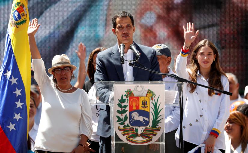  Venezuelan opposition leader Juan Guaido, who many nations have recognized as the country's rightful interim ruler, speaks next to his mother Norka Marquez and his wife Fabiana Rosales, as he attends a rally to commemorate the Day of the Youth and to protest against Venezuelan President Nicolas Maduro's government in Caracas, Venezuela February 12, 2019. REUTERS